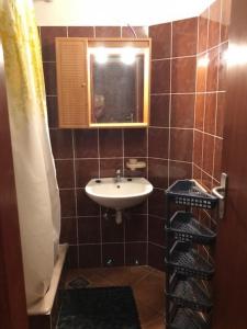 a bathroom with a sink and a mirror at Rooms with WiFi Susak, Losinj - 18208 in Susak