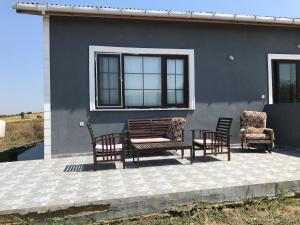 a patio with chairs and a bench and a house at Wifi Hafta sonu kaçamağı wifi in Gelibolu