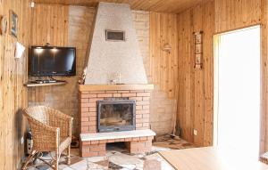 a living room with a fireplace and a tv at Awesome Apartment In Kopalino With 1 Bedrooms And Wifi in Kopalino