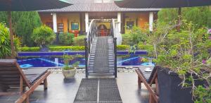 an outdoor stairway leading to a house with a pool at Flower Garden Lake Resort in Tissamaharama