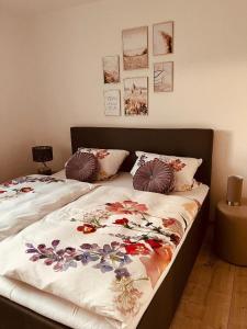 a bedroom with two beds with flowers on them at Ferienwohnung Elfi in Kirchdorf im Wald