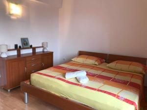 a bedroom with a bed with two pillows and a dresser at Apartments with parking space Katuni, Zagora - 18344 in Šestanovac