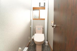 a bathroom with a white toilet in a room at Toya Blue in Lake Toya +36 photos