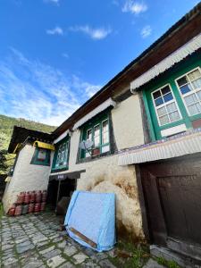 een huis met een blauw zeil ervoor bij Hotel Camp de Base in Namche