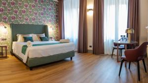 a bedroom with a bed and a table in a room at Castel Sant´Angelo Luxury Rooms & Tour in Rome