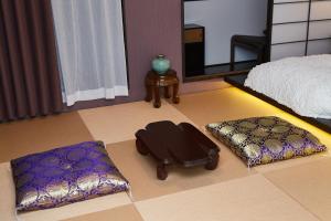 a rendering of a bedroom with a bed and a ottoman at Asakusa New City Hotel in Tokyo