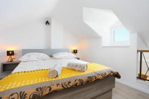 a bedroom with a bed with two towels on it at Apartments by the sea Igrane, Makarska - 18405 in Igrane
