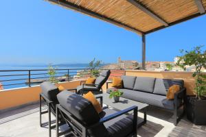 a patio with a couch and chairs on a balcony at Apartments by the sea Igrane, Makarska - 18405 in Igrane