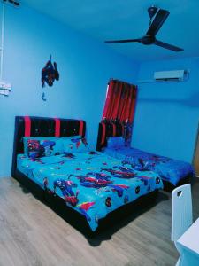 a bedroom with a bed with a spider man bedspread at WORLD KIDS FANTASY in Lumut