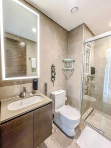 a bathroom with a toilet and a sink and a shower at STAY BY LATINEM Luxury 1BR Holiday Home CV A2604 near Burj Khalifa in Dubai