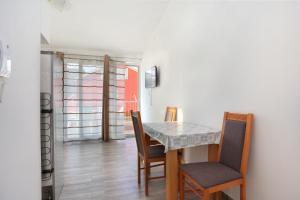 a dining room with a table and chairs at Apartments with a parking space Split - 18214 in Solin