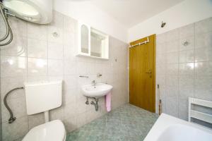 a bathroom with a sink and a toilet at Apartments with parking space Postira, Brac - 18472 in Postira