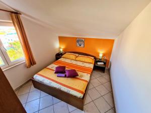 a bedroom with a bed with two pillows on it at Apartments by the sea Slatine, Ciovo - 18481 in Slatine