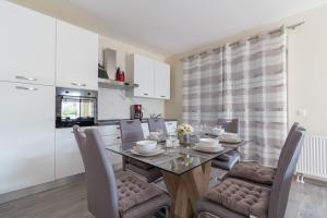 a kitchen and dining room with a table and chairs at Seaside luxury villa with a swimming pool Privlaka, Zadar - 18508 in Privlaka