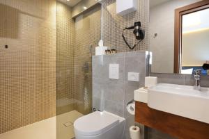 a bathroom with a toilet and a sink and a mirror at Rooms with a swimming pool Split - 18489 in Split