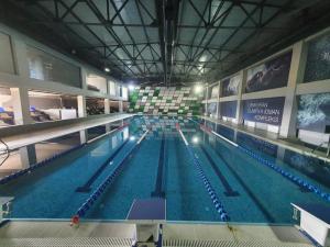 a large swimming pool in a large building at Arena Hotel Lankaran in Lankaran