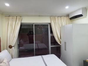 a bedroom with a bed and a sliding glass door at Sunnyridge Lodge in East London