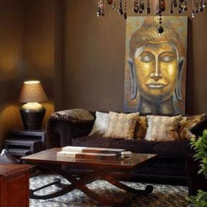 a living room with a couch with a head on the wall at Hotel el Jardín de Eugenia in Ribadesella