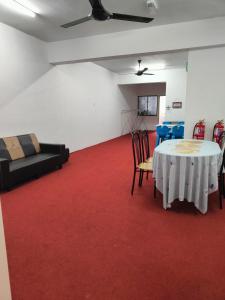 a room with a table and chairs on a red carpet at WORLD KIDS FANTASY in Lumut