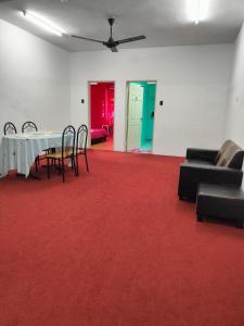 a room with a table and chairs on a red carpet at WORLD KIDS FANTASY in Lumut
