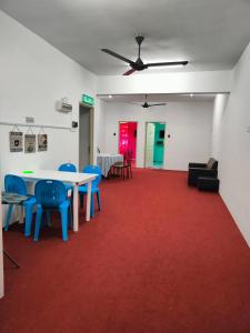 a room with a table and chairs and a red carpet at WORLD KIDS FANTASY in Lumut