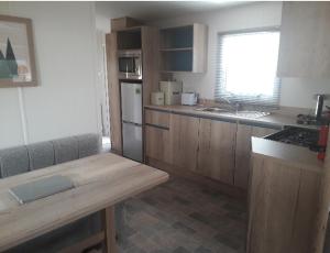 a kitchen with wooden cabinets and a counter top at Camelot Holiday Park, Longtown, Tranquility 21 Coworth in Carlisle