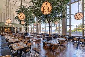 a restaurant with tables and chairs and large windows at Hualien Farglory Hotel in Yanliau