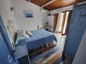 a bedroom with a bed with a blue comforter at Vivienda rural del salado in Jaén