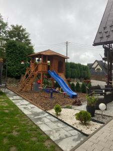 a playground with a slide in a backyard at willa anulka na Hrubym in Zakopane