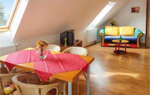 a living room with a table and a couch at Stunning Home In Grzybowo in Grzybowo