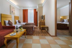 A bed or beds in a room at Alaiye Resort & Spa Hotel - Ultra All Inclusive