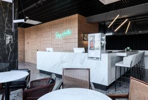 a restaurant with tables and chairs and a counter at WOL 121 by Ribas in Odesa