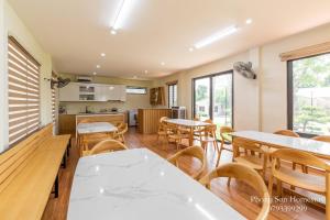 a kitchen and dining room with tables and chairs at Phong Sơn Villa - Venuestay in Hanoi