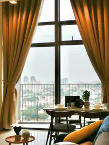 a room with two tables and a large window at Moka Eko Cheras in Kuala Lumpur