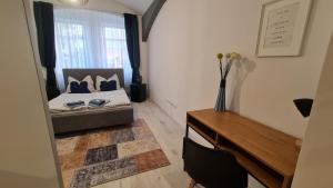 a bedroom with a bed and a desk and a window at Apartment near Congress Centre I. in Prague