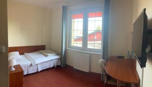 Łóżko lub łóżka w pokoju w obiekcie Hotel Gryf