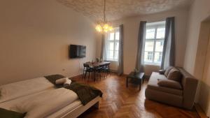 a living room with a bed and a couch at commodious 3BR Apt. Ideal for Families and Friends in Vienna