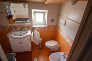 a bathroom with a toilet and a sink at CASA TERESA NEL CENTRO DI VIETRI in Vietri