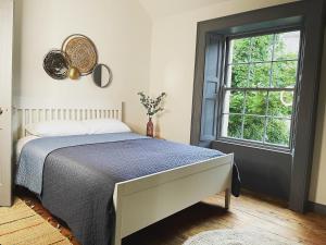 a bedroom with a bed and a window at Old Dublin ‘Four sisters’ in Dublin