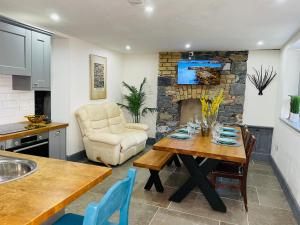 a kitchen and living room with a table and a chair at Old Dublin ‘Four sisters’ in Dublin