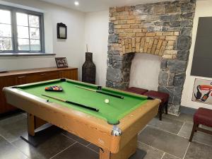 a room with a pool table and a fireplace at Old Dublin ‘Four sisters’ in Dublin