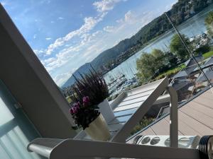 a balcony with a chair and a view of the water at BrixHome in Laveno-Mombello