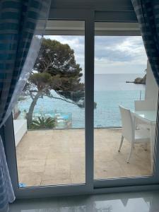 Elle offre une vue sur l'océan depuis sa fenêtre. dans l'établissement Hotel La Calanque, à Cavalaire-sur-Mer