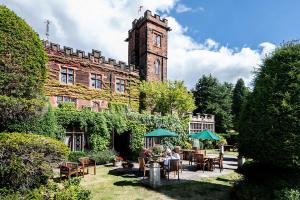 a group of people sitting at a table in front of a building at New Hall Hotel & Spa, Birmingham in Birmingham