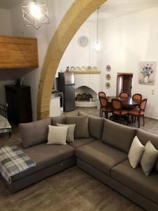 a living room with a couch and a table at Amalia's Traditional Home in Paradisi in Paradeísion