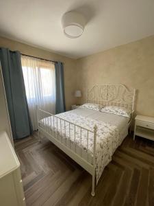 a bedroom with a white bed and a window at Apartments Sanja in Krk