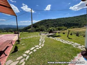 a garden with a rock pathway in the grass at Domek w Chmurach in Kicznia +38 photos