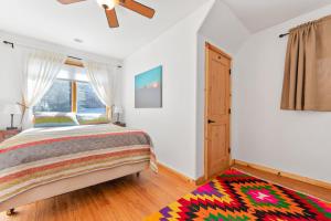 a bedroom with a bed and a window and a rug at Oso Lodge in Yosemite West