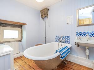 a bathroom with a large tub and a sink at Anglers Cottage in Skipton +21 photos