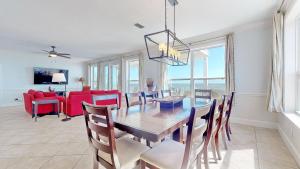 a dining room with a table and chairs and a room with a view at Barefoot Bungalow in St. George Island